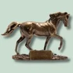 Bronzeskulptur af en hest på en piedestal.