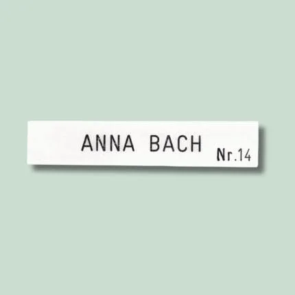 Hvidt navneskilt med teksten Anna Bach, nr. 14